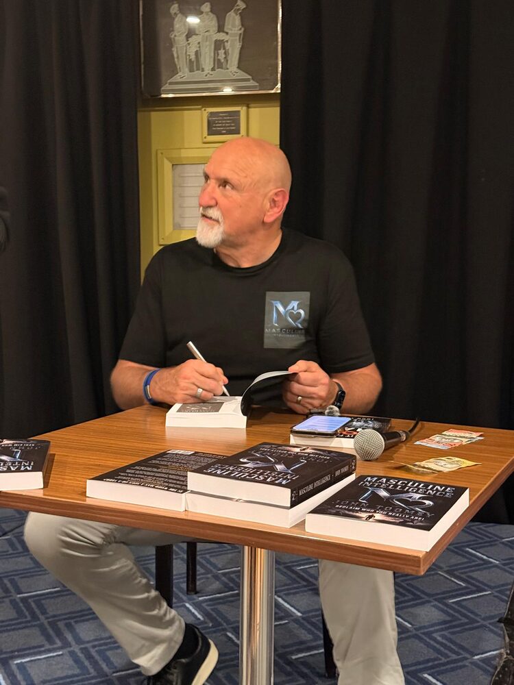 John Toomey signing a copy of Masculine Intelligence